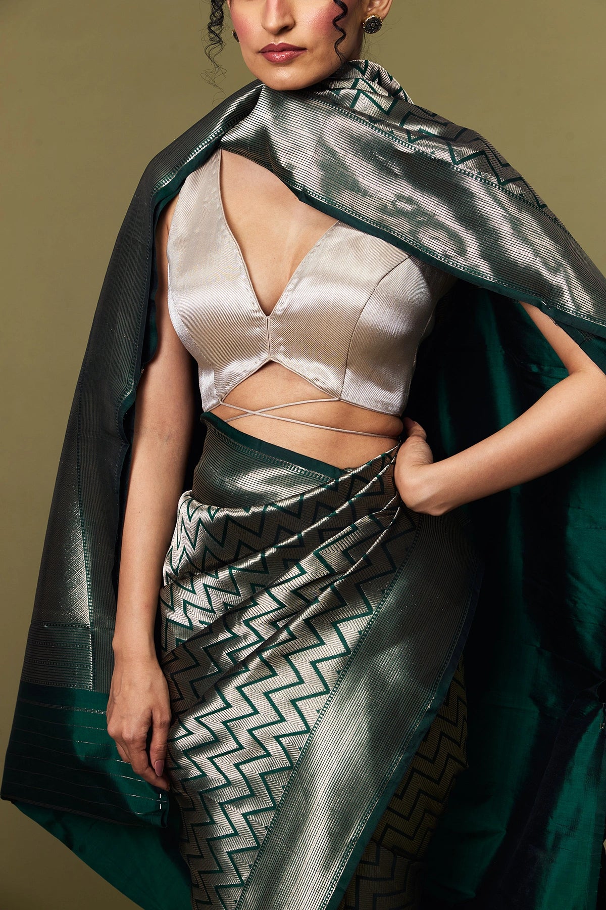 Model draped in emerald green Banarasi Katan silk saree with geometric zari pattern