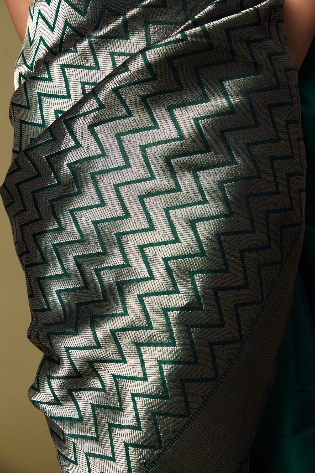 Close-up of zig-zag zari pallu in green Banarasi silk saree