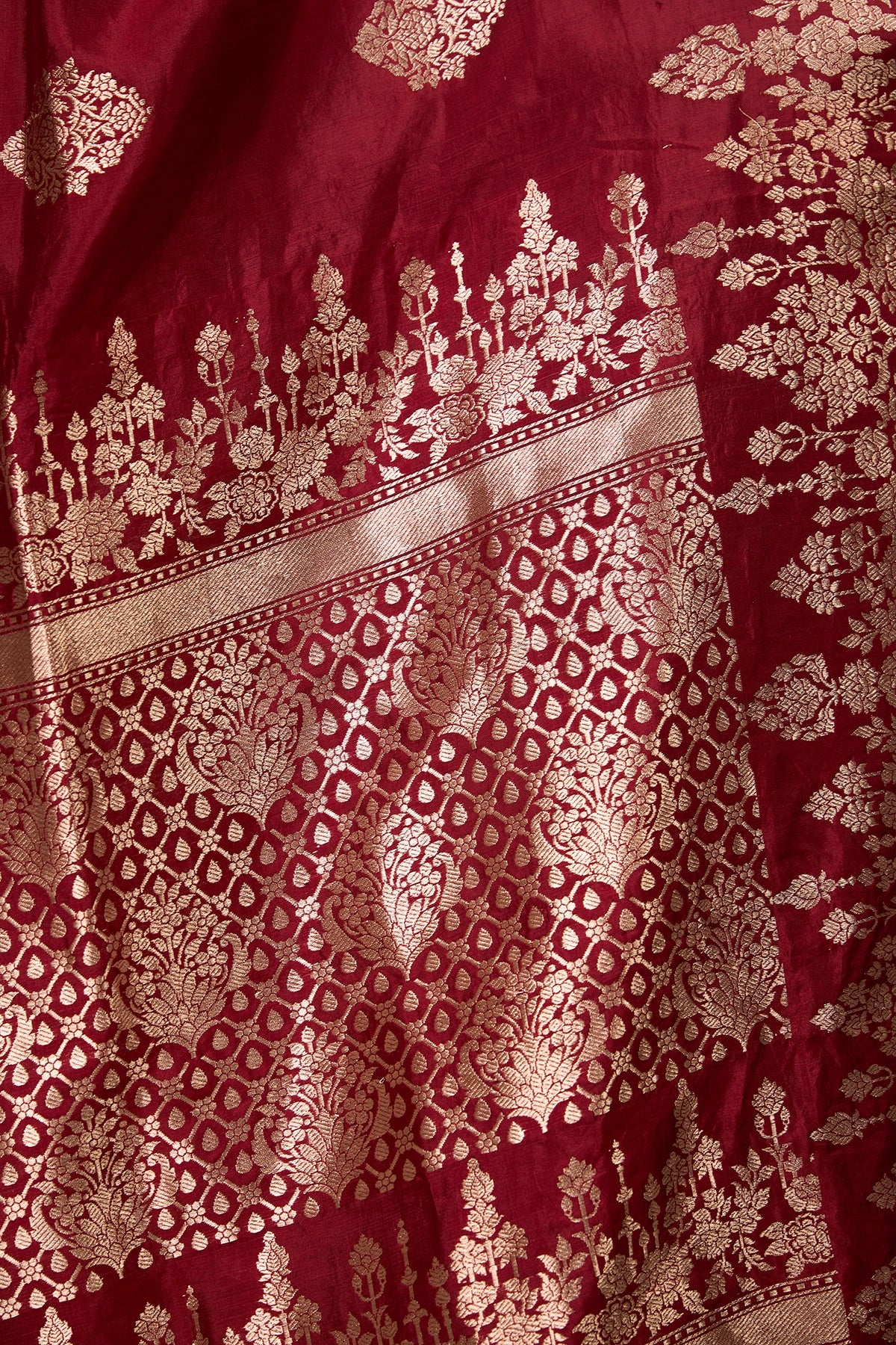 Close-up of floral zari pallu in maroon Banarasi mango silk saree