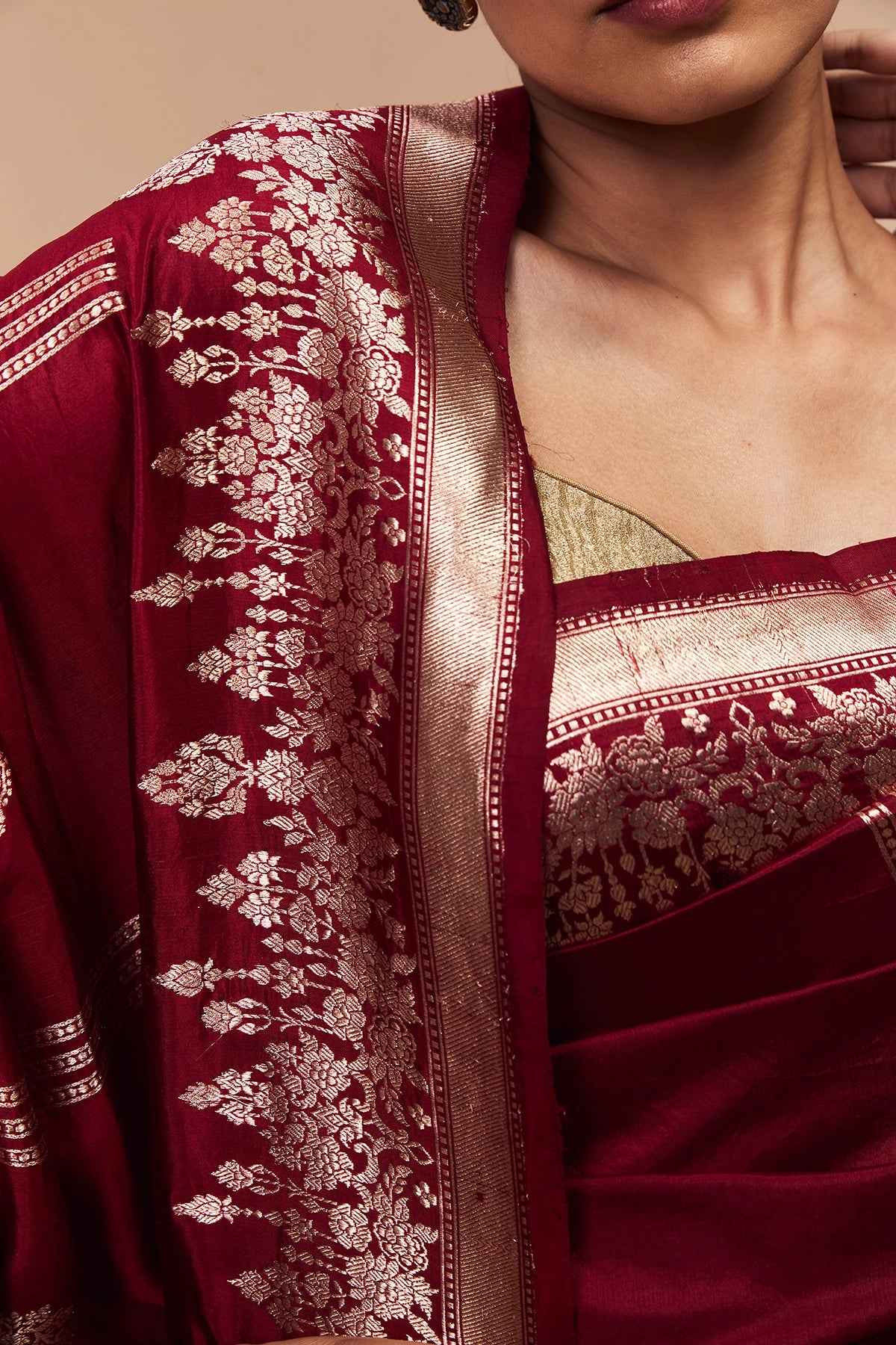 traditional floral zari border on maroon Banarasi silk saree