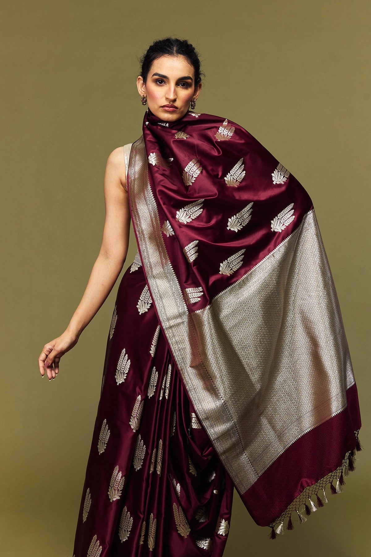 Banarasi Mashru silk saree folded to showcase contrast between floral design, zari border, and shimmering silk texture.
