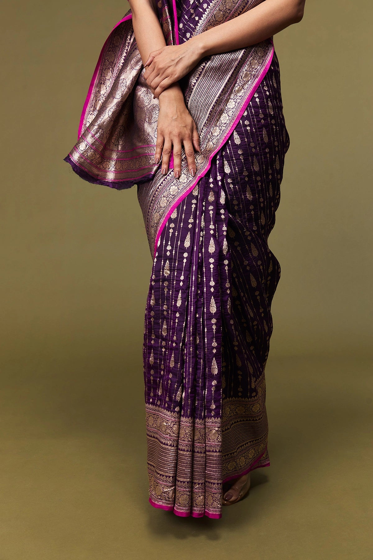 Folded view showing the rich texture, border, and shimmering body of the saree.