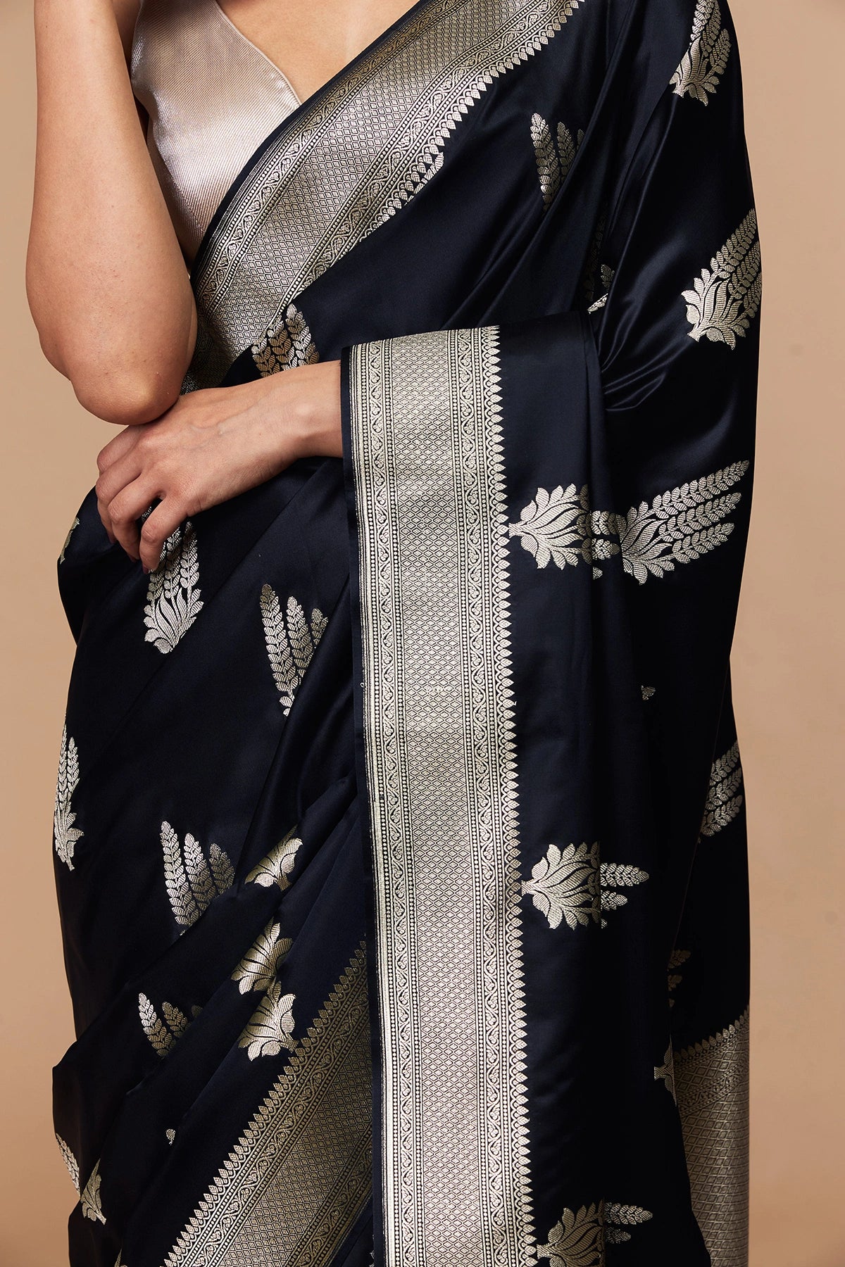 Close-up of silver zari pallu on black Banarasi silk saree