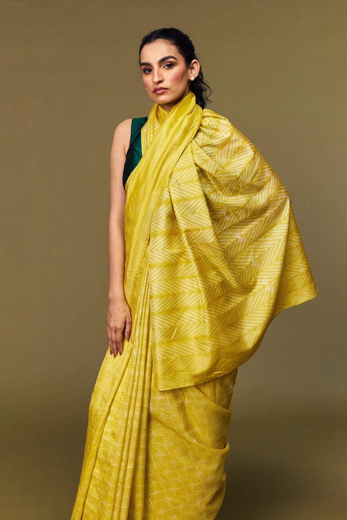 Artisan tie-dye details on yellow silk fabric