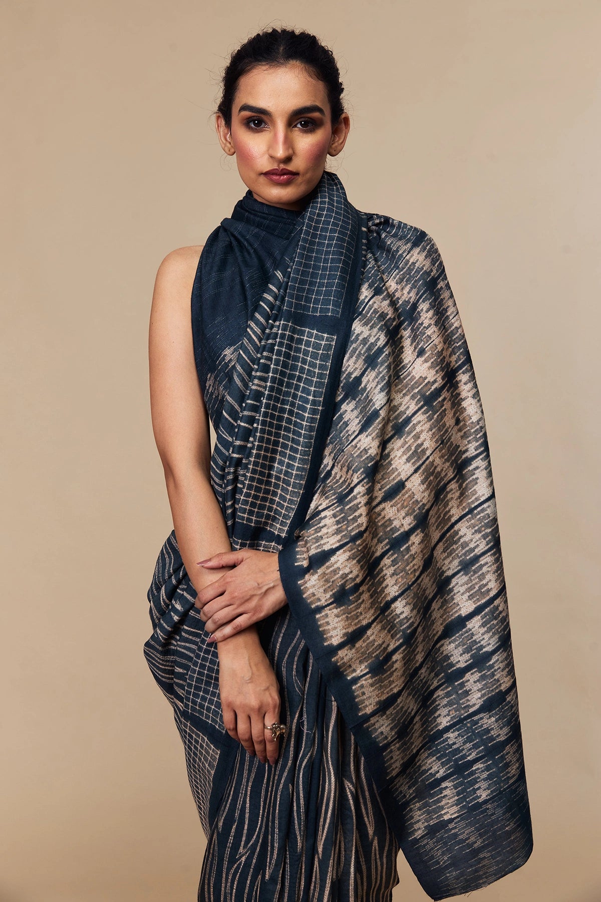 Detailed pleats with beige motif detailing on indigo silk