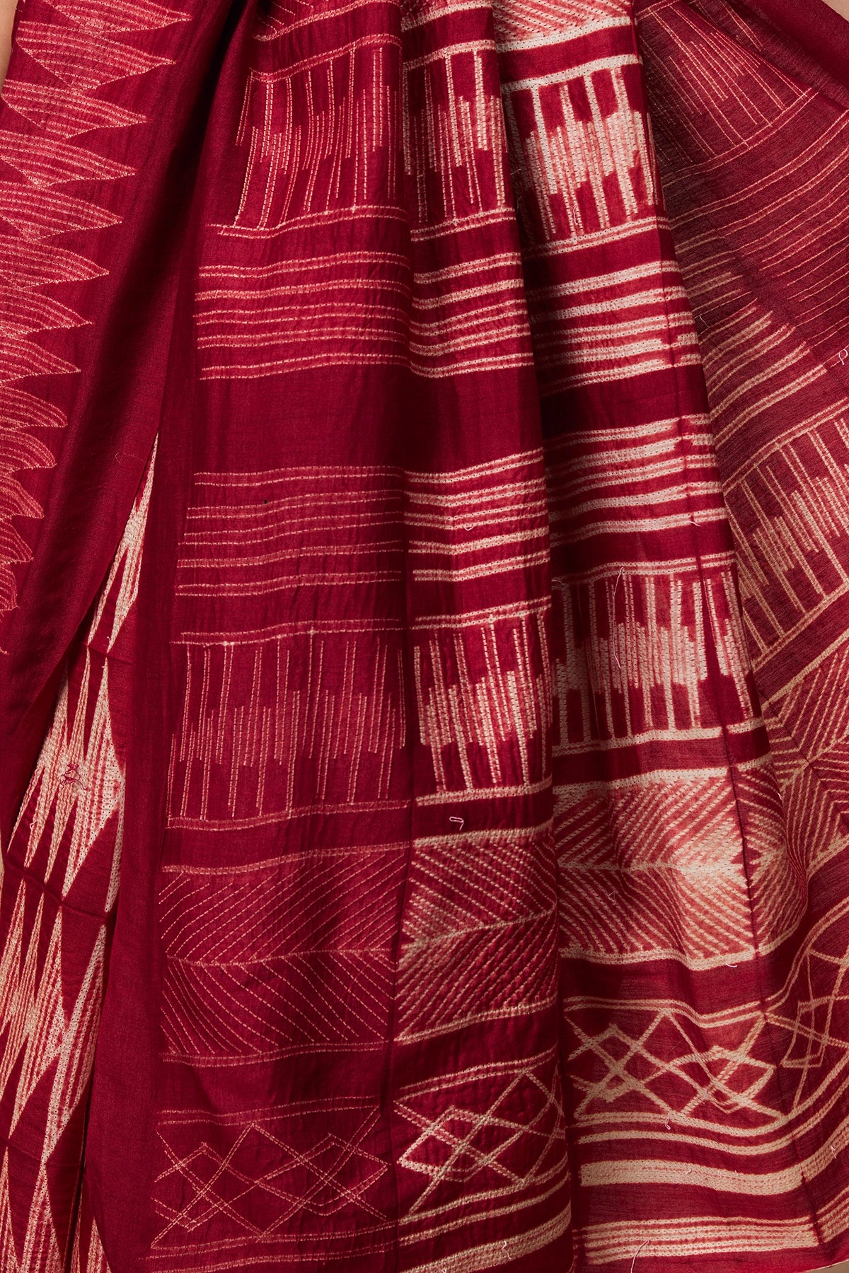 Close-up of pallu showing layered Shibori lines and grids