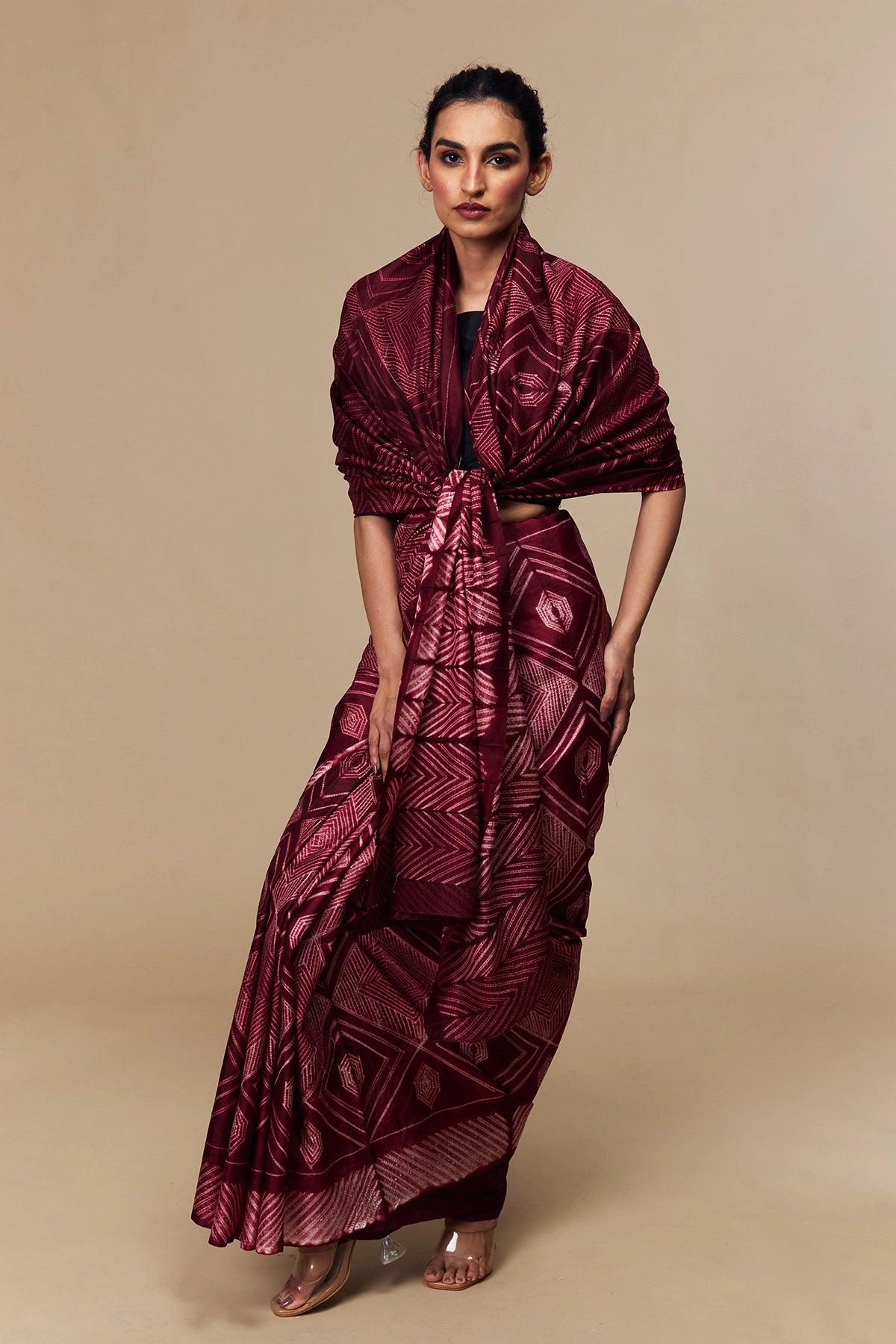 Model wearing maroon Tussar silk saree with geometric Shibori design