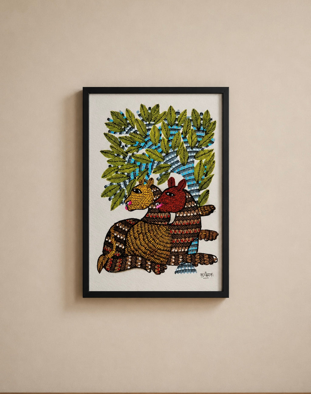 A framed folk art print depicting two armadillos under a leafy tree, mounted on a beige wall.