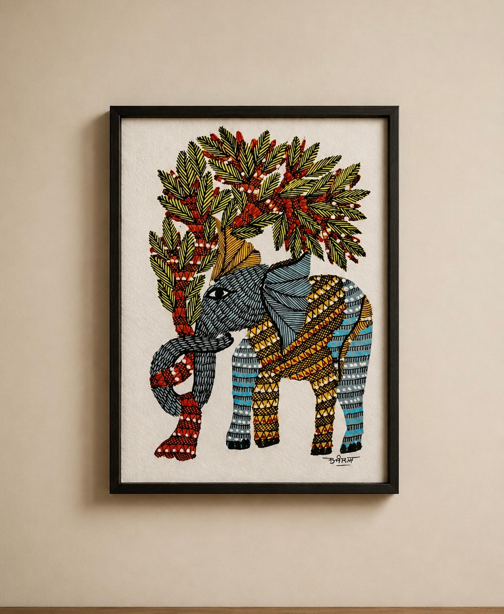 A framed art print featuring a stylized elephant decorated with geometric patterns in blue, yellow, and red, carrying a tree with green leaves and red berries. The artwork is presented in a black frame on a beige wall.