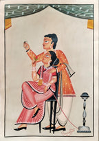 A traditional Indian folk art print depicting a seated woman in a pink and red sari being held by a standing man in an orange patterned kurta. The scene is framed with a decorative border and a small lamp on the right, set against a warm beige background.