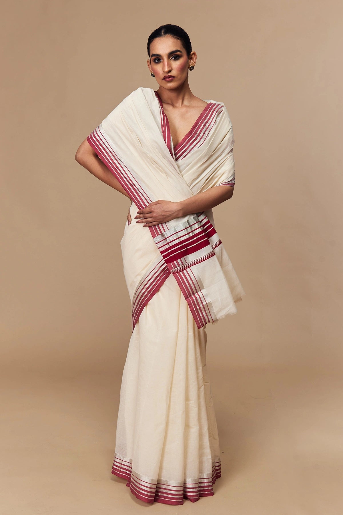 Draped front showcasing traditional Kerala design in white and red