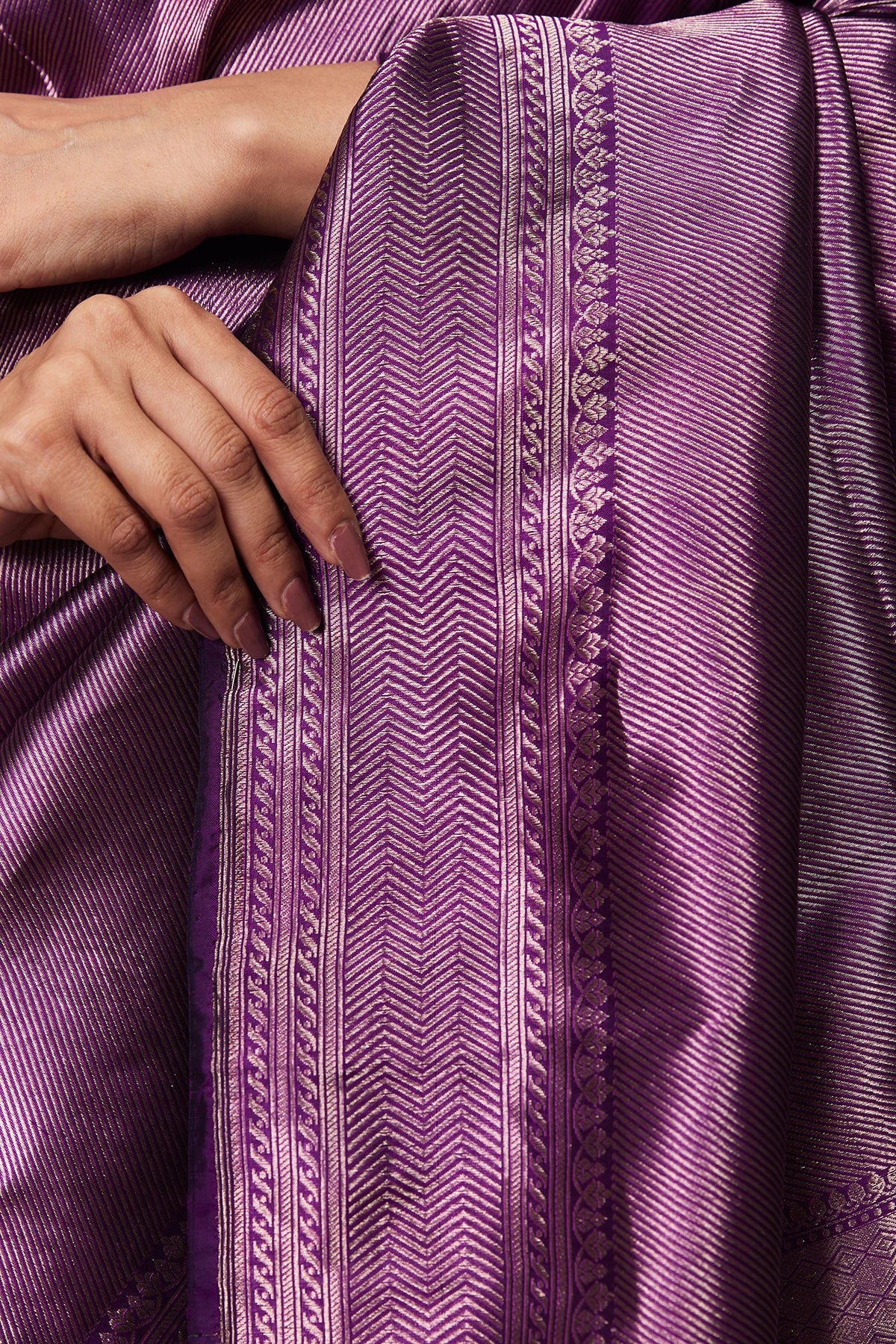 Close-up of violet Banarasi saree pallu with self-zari weave