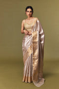 Model draped in champagne gold tissue Banarasi saree with zari border