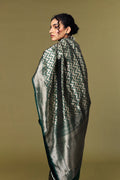 Model draped in emerald green Banarasi Katan silk saree with geometric zari pattern