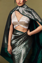 Model draped in emerald green Banarasi Katan silk saree with geometric zari pattern