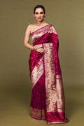 Model draped in deep pink Katan silk Banarasi saree with Ghat motifs and antique zari