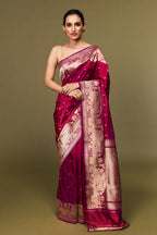 Model draped in deep pink Katan silk Banarasi saree with Ghat motifs and antique zari