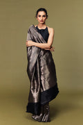 Model draped in black Banarasi Tanchoi silk saree with brocade pattern