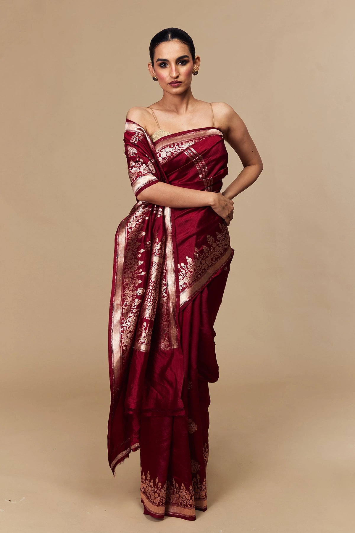 Model draped in maroon mango silk Banarasi saree with zari buti work