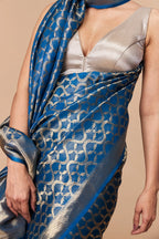 Close-up of shimmering gold pallu in blue satin tissue Banarasi saree