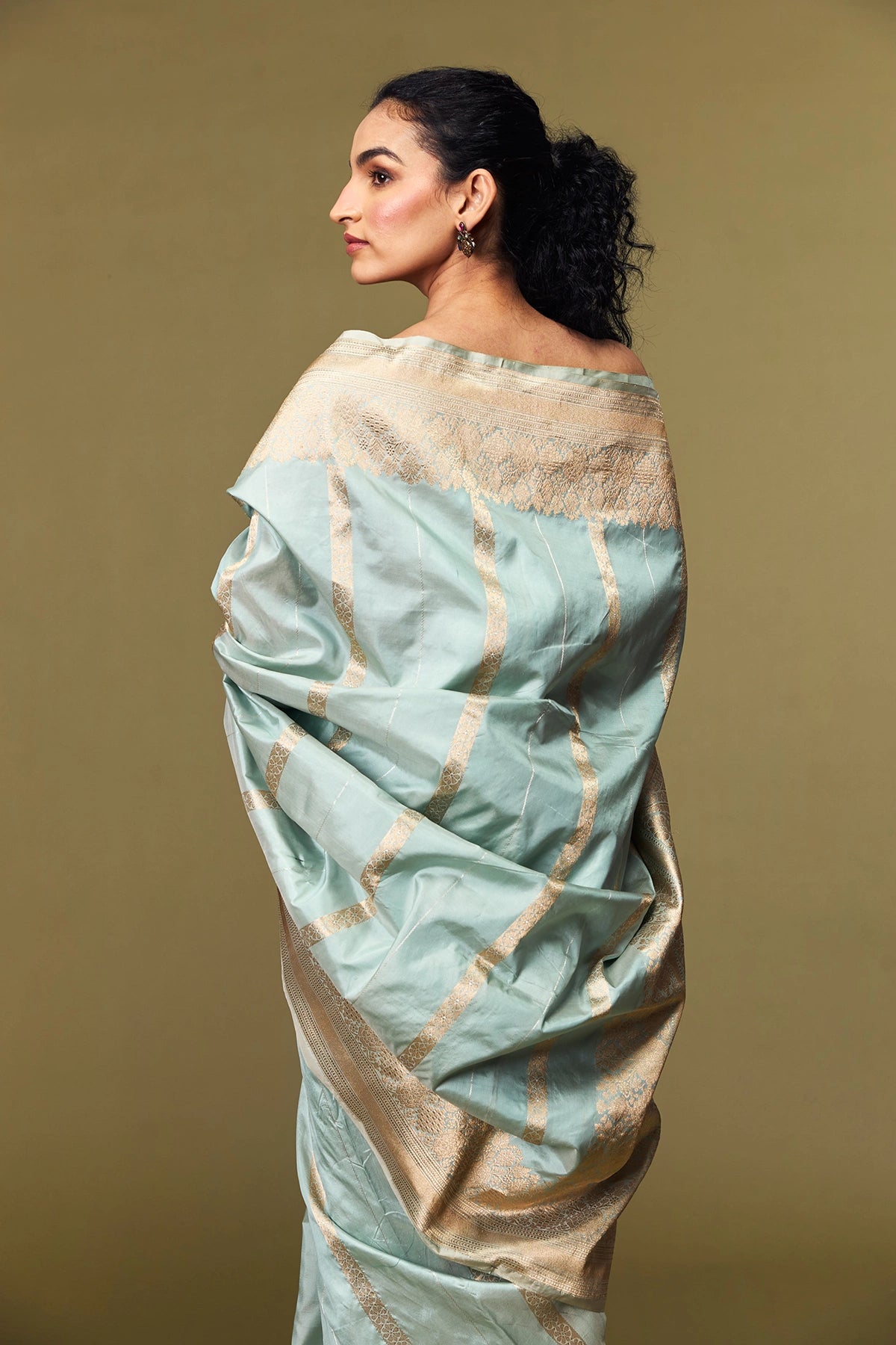 Intricate gold zari border of mint green Katan silk saree