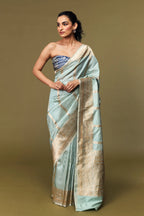 Model draped in mint green Katan silk Banarasi saree with gold Kadhwa butis