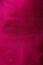 Unstitched blouse piece in matching purple silk included with the saree.