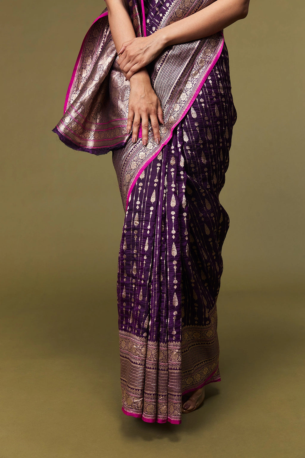 Folded view showing the rich texture, border, and shimmering body of the saree.