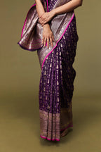 Folded view showing the rich texture, border, and shimmering body of the saree.