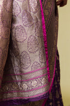 Close-up of the zari work and intricate border detailing on the Banarasi silk saree.