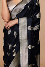 Close-up of silver zari pallu on black Banarasi silk saree