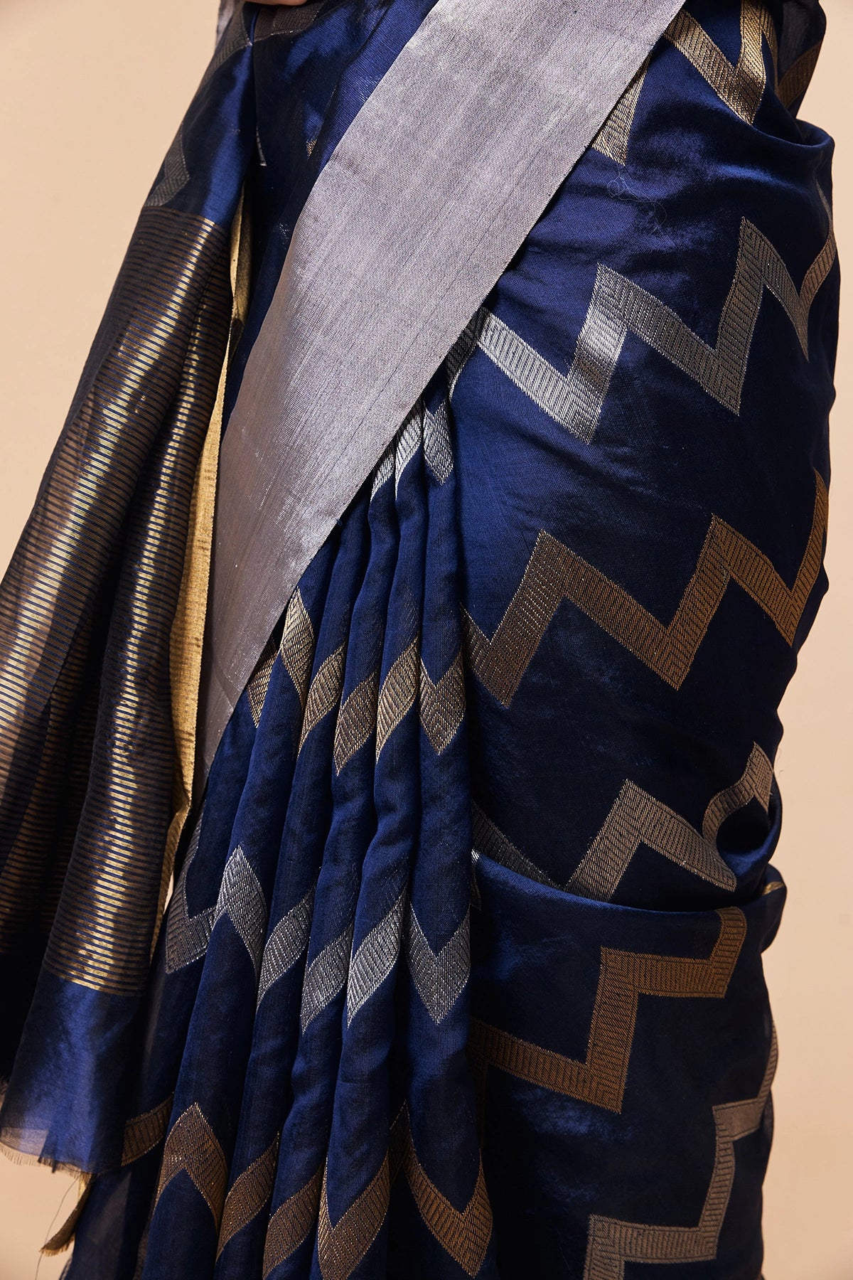 Close-up of navy blue Chanderi saree with zigzag zari design