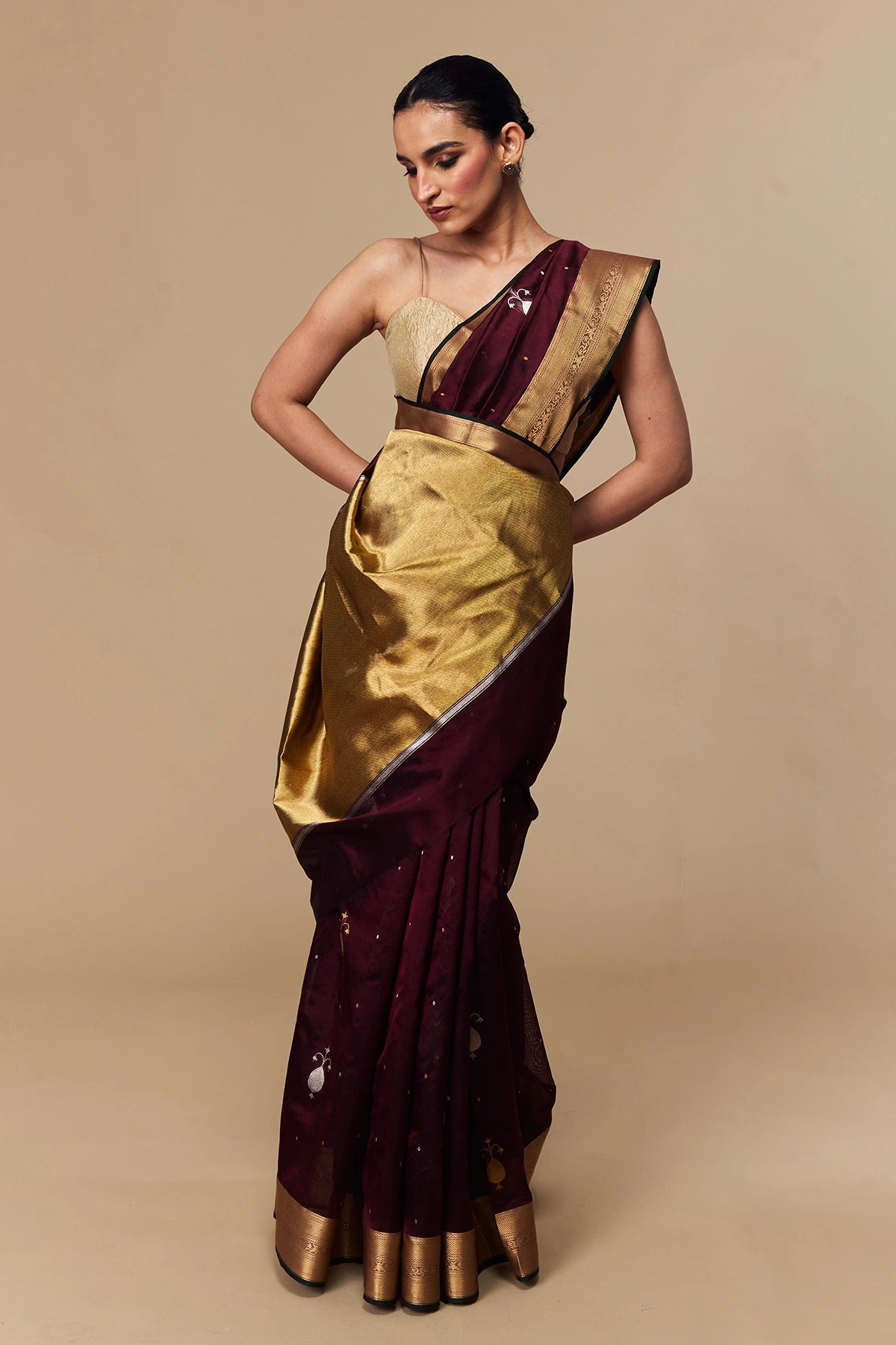 Draping view of maroon saree with gold palla