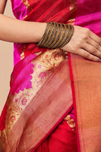 Close-up of floral zari weaving on pink Chanderi silk saree