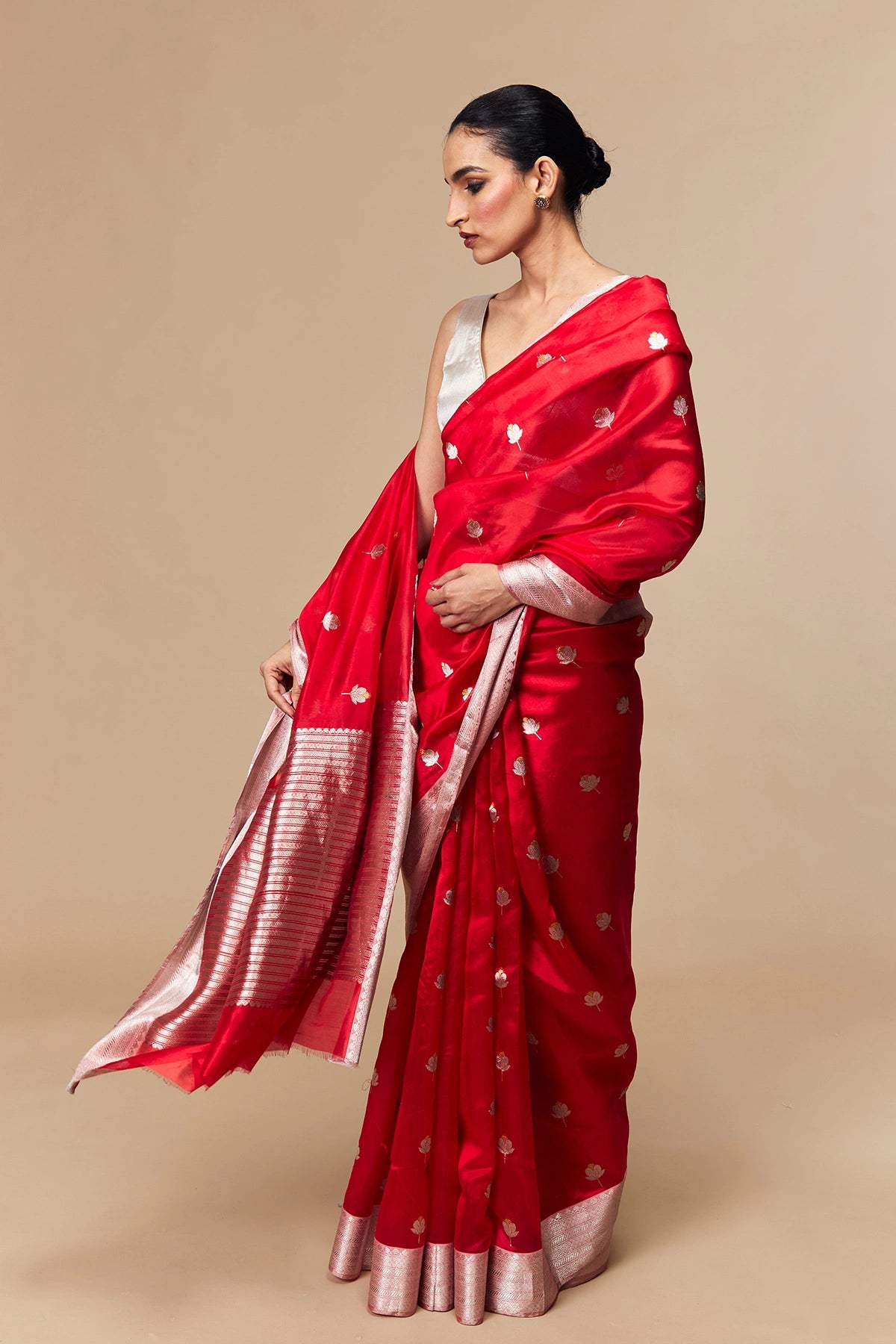 Model draped in red Chanderi silk saree with silver zari border