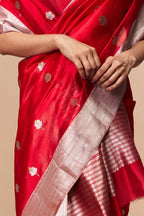 Close-up of floral silver zari motifs on red silk