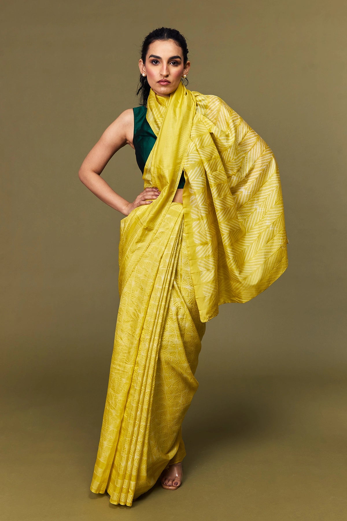 Full view of model draped in yellow Shibori silk saree