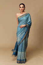Close-up of teal blue Tussar silk saree with zigzag Shibori patterns
