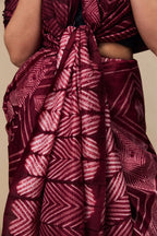 Close-up of concentric Shibori motifs on maroon silk fabric
