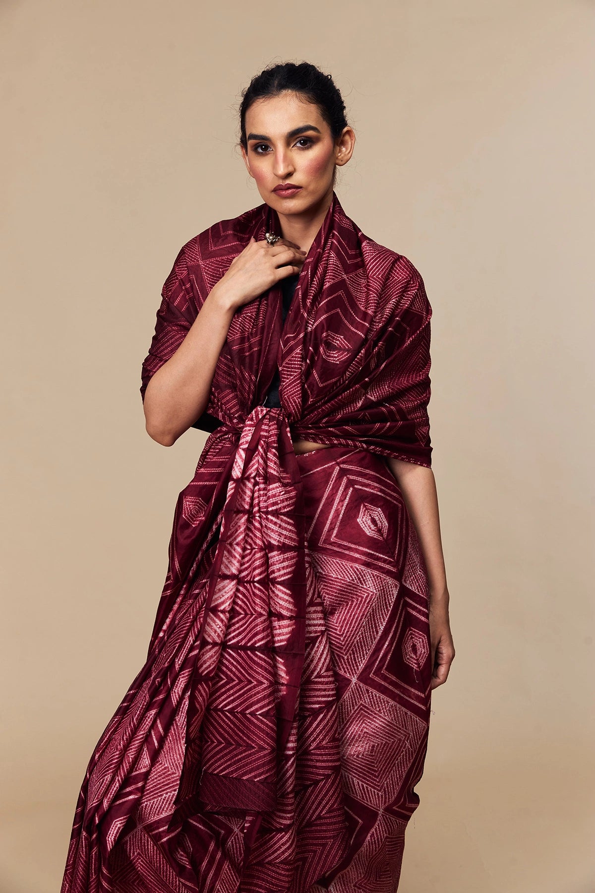 Model wearing maroon Tussar silk saree with geometric Shibori design