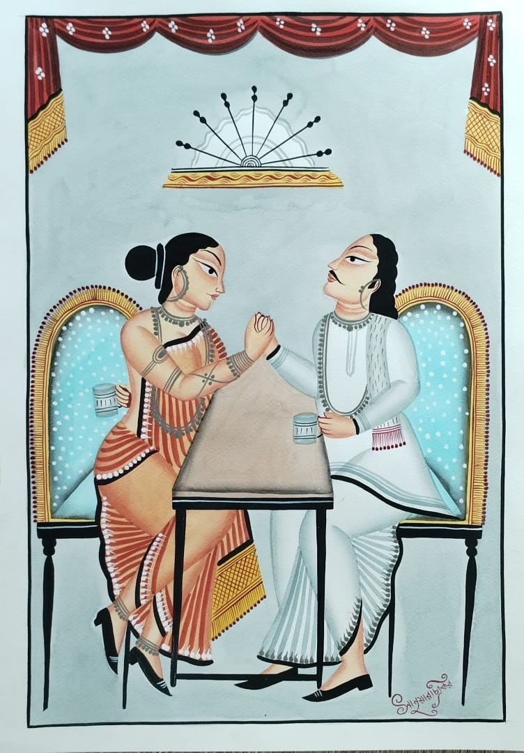 A traditional Indian folk art painting depicting two women seated at a table, one in an orange and white sari and the other in a white kurta, set against a light blue background with red drapery at the top.