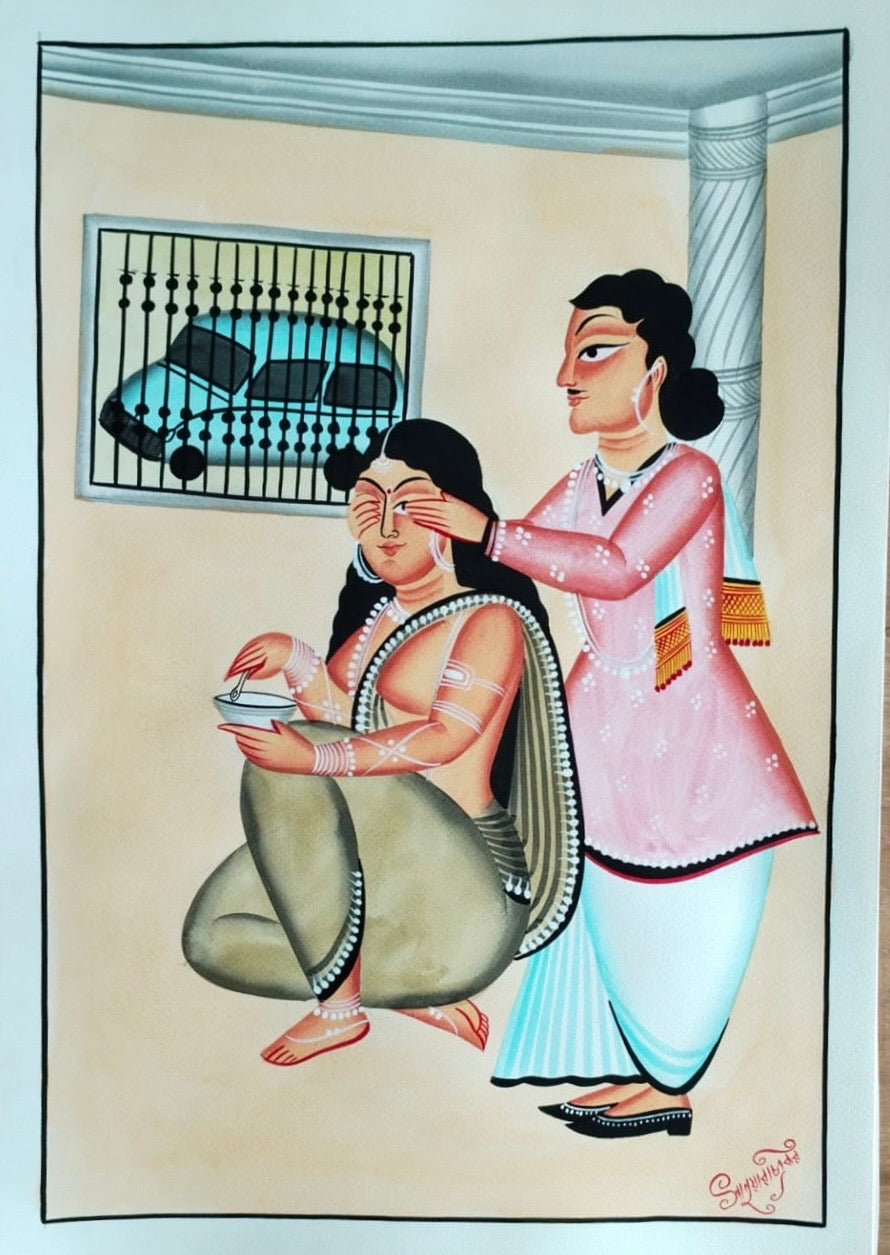 A traditional Indian folk art painting depicting a woman applying makeup or powder to another woman's face in an indoor setting. The artwork features a seated woman in a green saree and a standing woman in a pink kurta and light blue skirt, set against a beige background with a window and pillar.